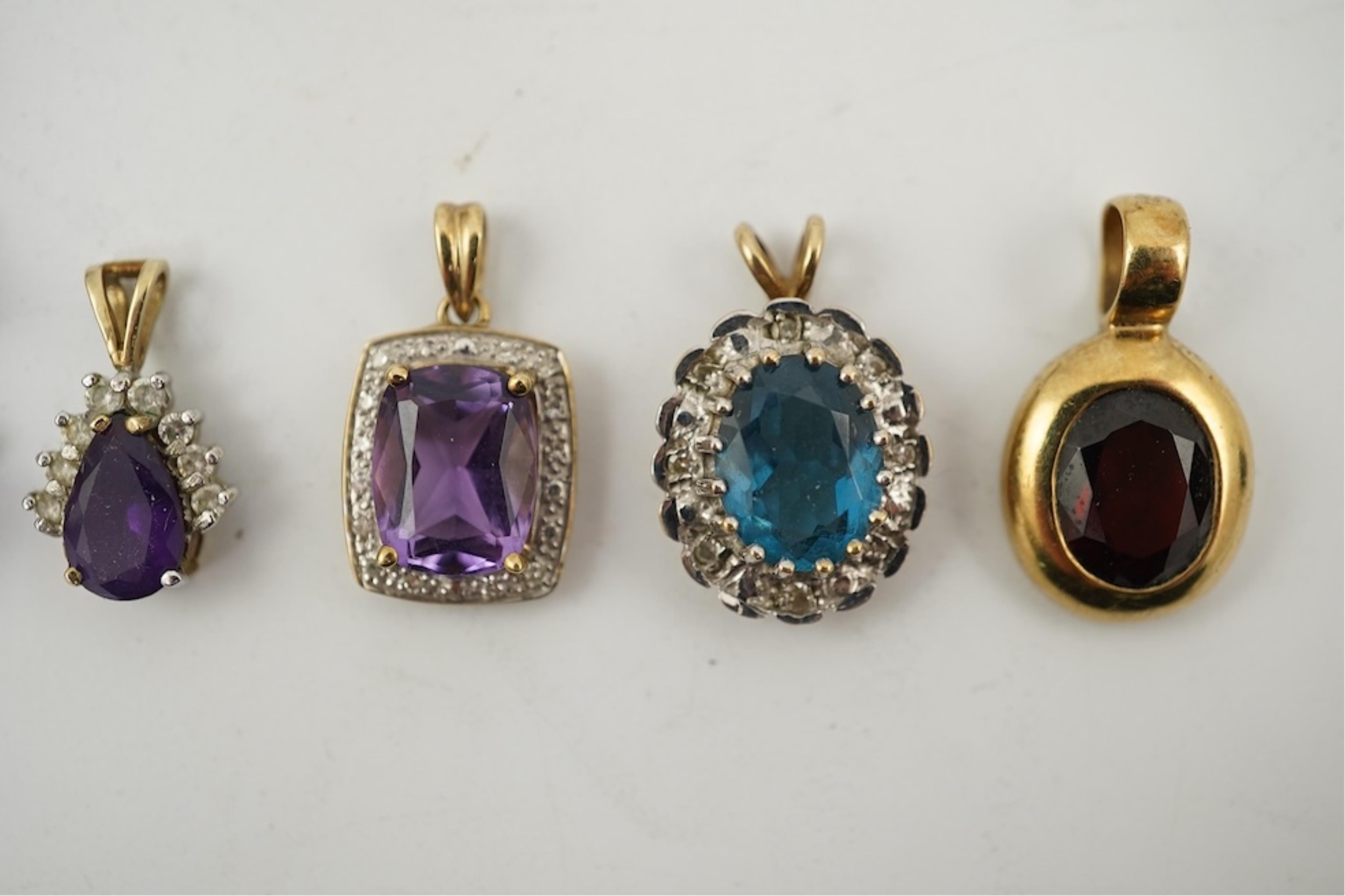 Five assorted modern 375 yellow metal and gem set pendants, a yellow metal and lapis lazuli set pendant (stamped 585?) 40mm, together with a yellow metal dragonfly brooch, a similar small pendant and a white metal bracel